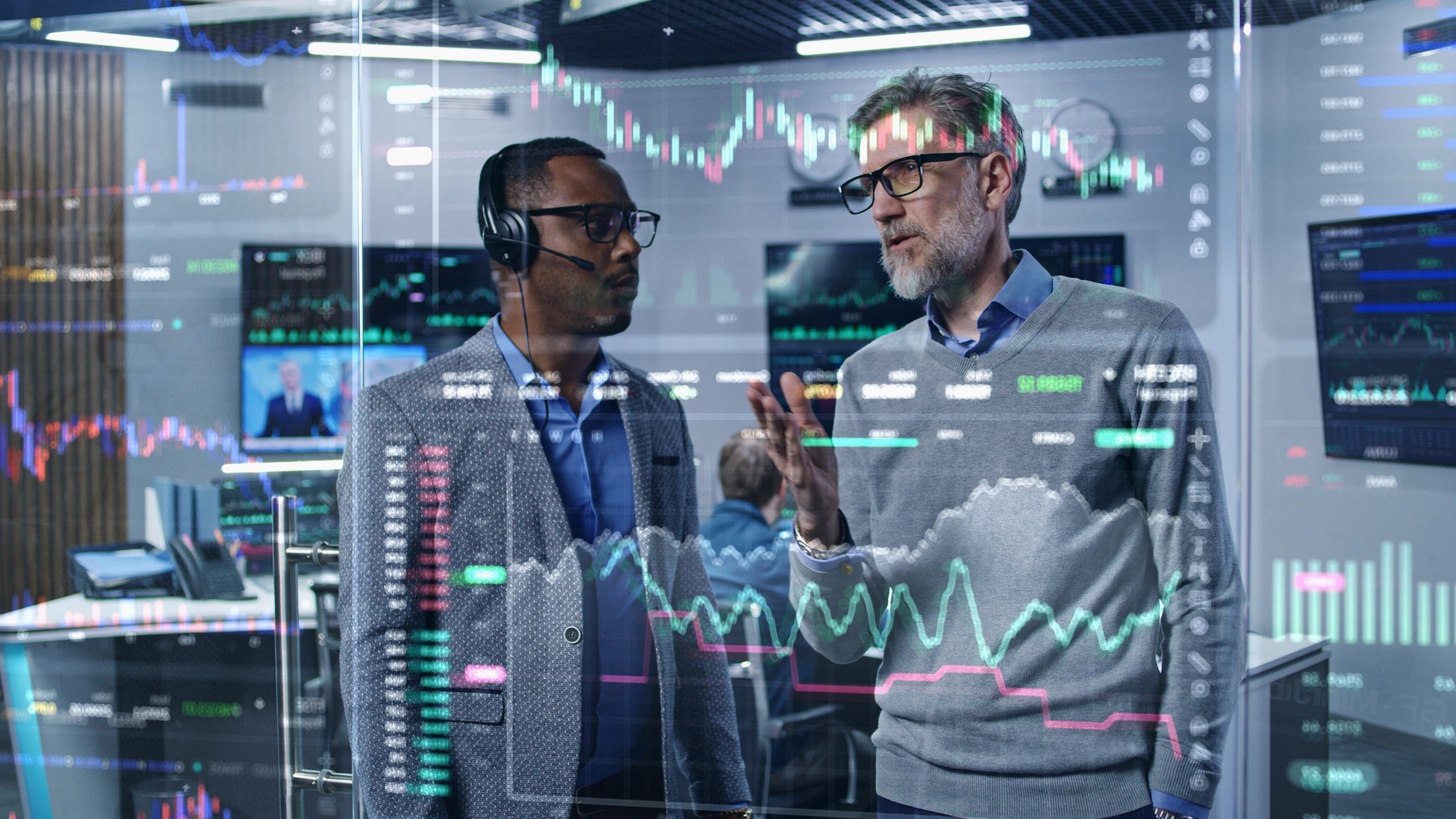 Financial analysts reviewing global market data on digital screens