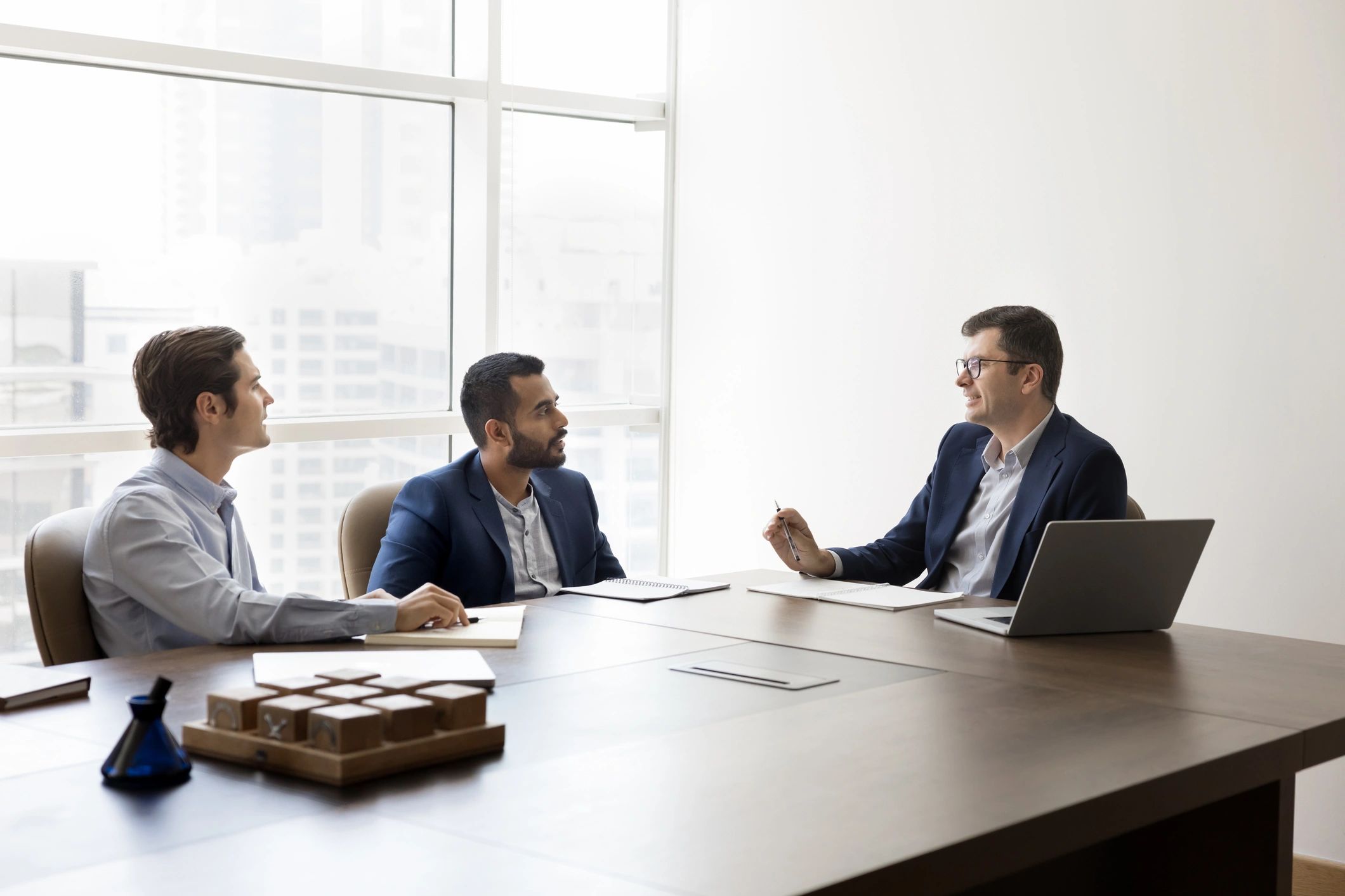 Business leaders in a premium meeting room discussing financial strategy